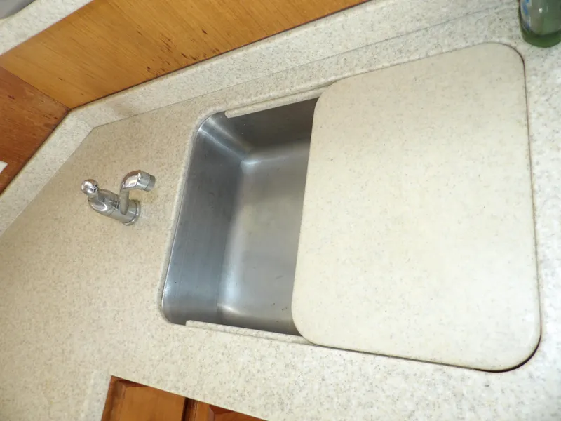 Slide: The Image of 1999 Mainship 350 Trawler kitchen sink with cover and faucet. - 43
