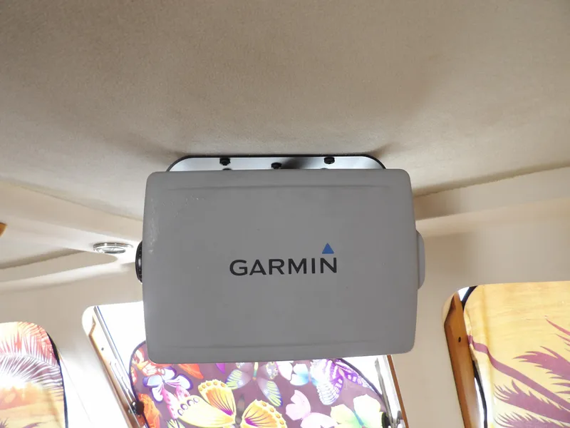 Slide: The Image of Garmin device installed on 1999 Mainship 350 Trawler ceiling, with colorful interior decor. - 46