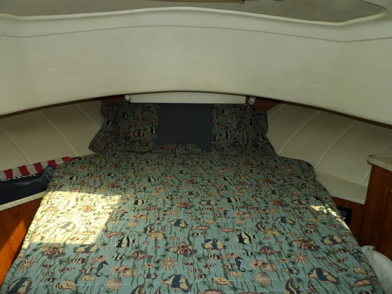 Slide: The Image of Cozy cabin interior of 1999 Mainship 350 Trawler with patterned bedding. - 48