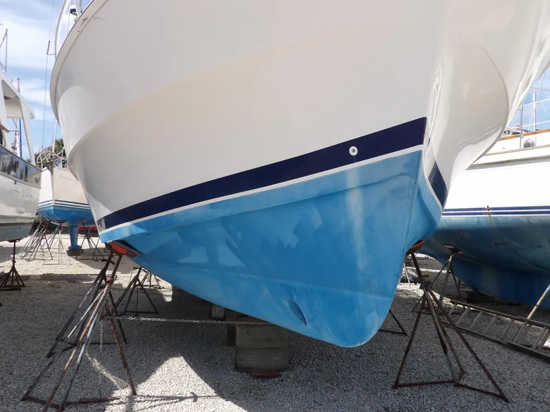 Slide: The Image of 1999 Mainship 350 Trawler on stands, blue hull, white upper section. - 5