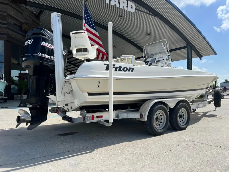 Slide: The Image of 2009 Triton 220 LTS boat on trailer with Mercury engine, parked outside. - 10