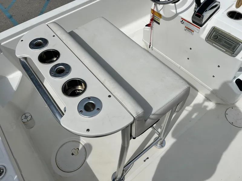 Slide: The Image of 2009 Triton 220 LTS boat interior with seating and cup holders. - 3