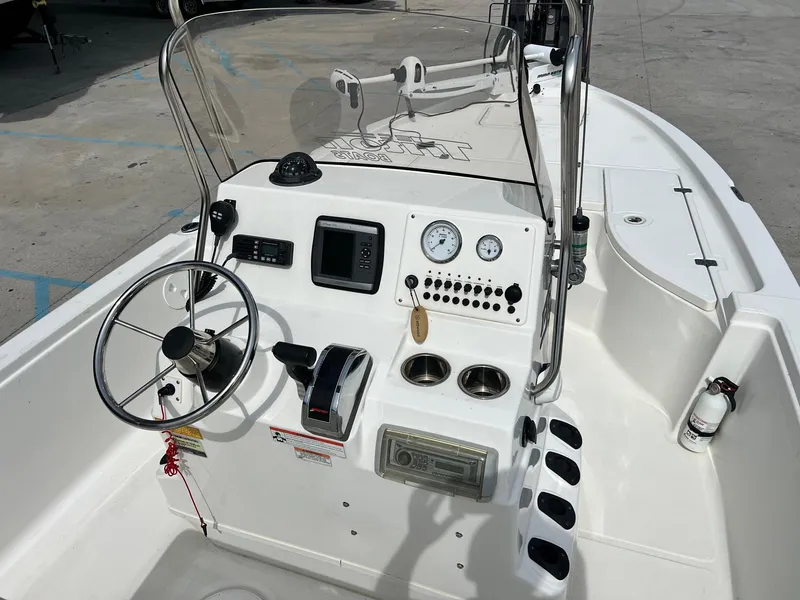 Slide: The Image of 2009 Triton 220 LTS boat console with steering wheel, gauges, and controls. - 5