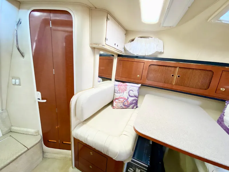 Slide: The Image of Interior of 2001 Sea Ray 290 Sundancer with seating and storage cabinets. - 13