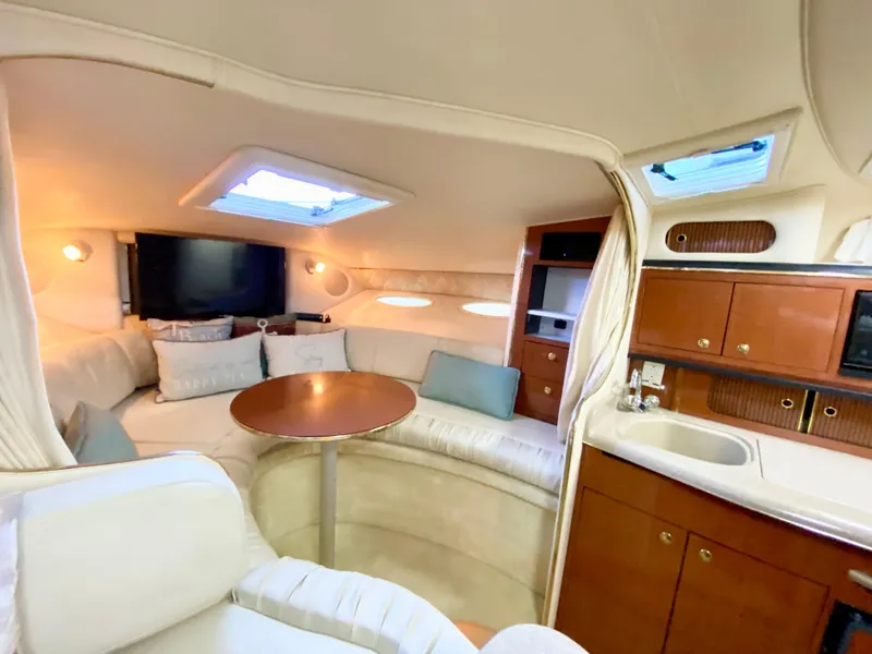 Slide: The Image of Luxurious interior of 2001 Sea Ray 290 Sundancer yacht with seating and kitchenette. - 18
