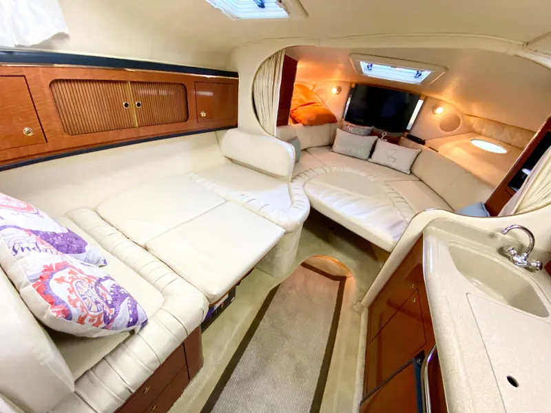 Slide: The Image of Interior of 2001 Sea Ray 290 Sundancer yacht with cozy seating and elegant design. - 19