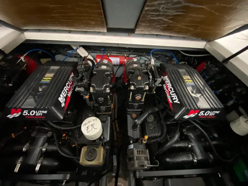 Slide: The Image of Twin Mercury 5.0L engines in a 2001 Sea Ray 290 Sundancer boat. - 26