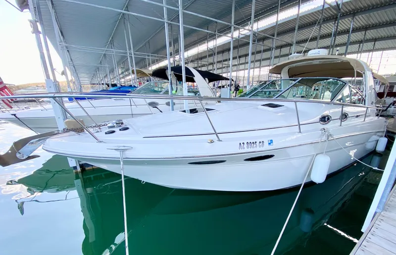 Slide: The Image of 2001 Sea Ray 290 Sundancer docked in a marina under a covered structure. - 4