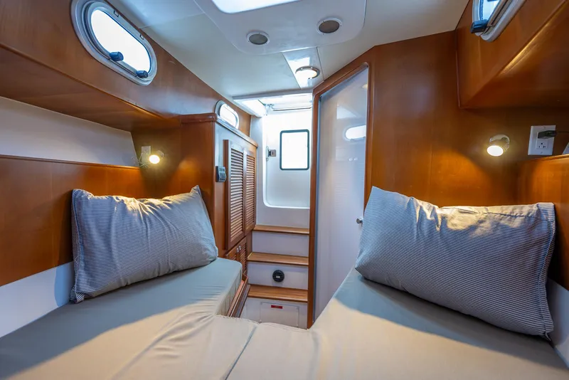 Slide: The Image of Cozy cabin interior of 2024 SeaPiper 37 with twin beds and wooden finish. - 15
