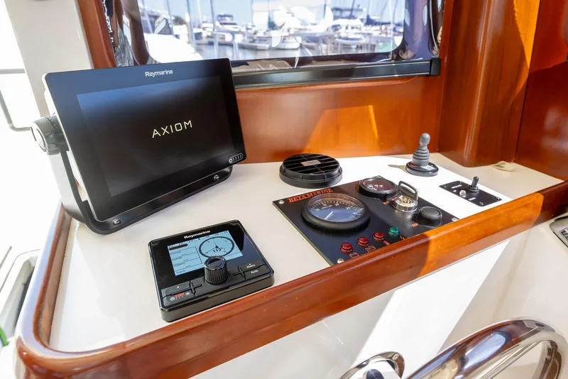 Slide: The Image of SeaPiper 37 helm with navigation controls and Raymarine Axiom display, 2024 model. - 16