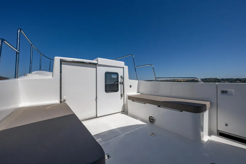 Slide: The Image of 2024 SeaPiper 37 boat deck with seating under clear blue sky. - 2