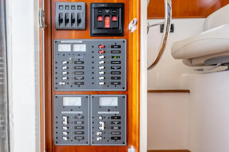 Slide: The Image of Electrical control panel on 2024 SeaPiper 37 boat, featuring switches and meters. - 21