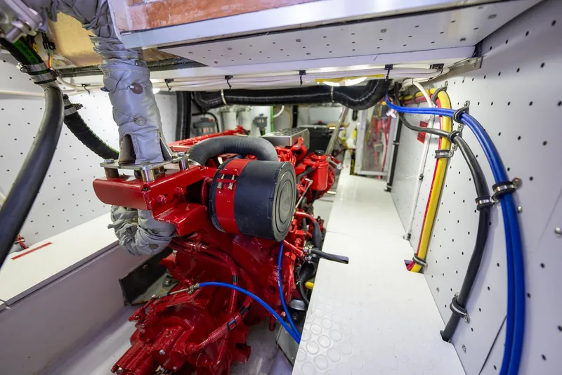 Slide: The Image of Engine room of 2024 SeaPiper 37 boat with red machinery and cables. - 22