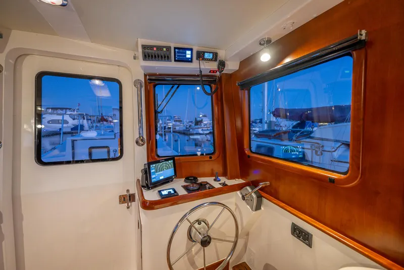 Slide: The Image of Interior of 2024 SeaPiper 37 boat, featuring navigation equipment and wooden accents. - 9