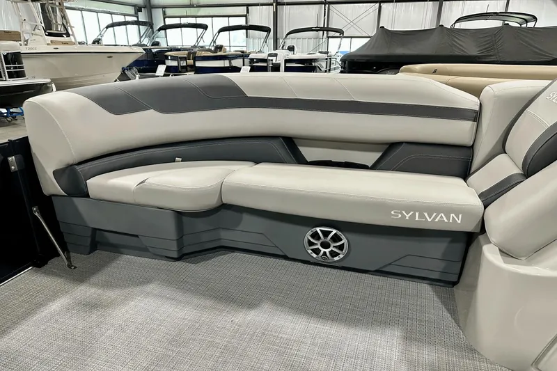 Slide: The Image of Luxurious seating in a 2025 Sylvan L-5 boat, featuring sleek design and integrated speaker. - 12