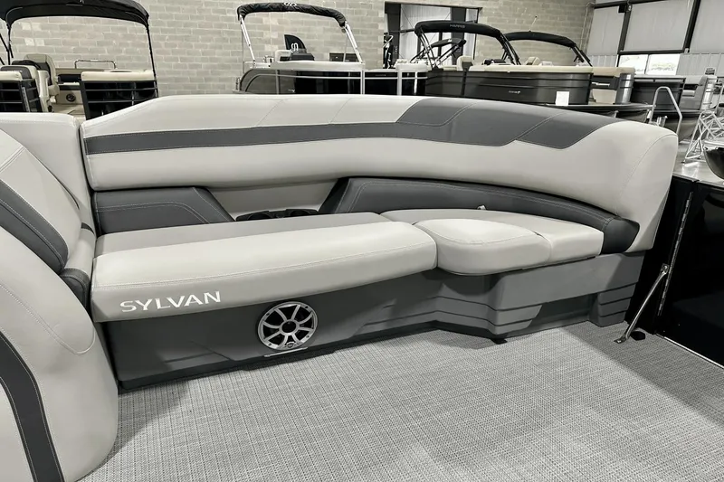 Slide: The Image of 2025 Sylvan L-5 boat interior with gray seating and speaker detail. - 13