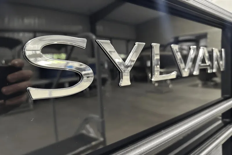Slide: The Image of 2025 Sylvan L-5 logo in a sleek, modern showroom setting. - 2