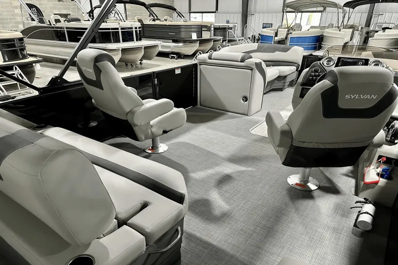 Slide: The Image of Interior of 2025 Sylvan L-5 pontoon boat with modern seating and dashboard. - 27