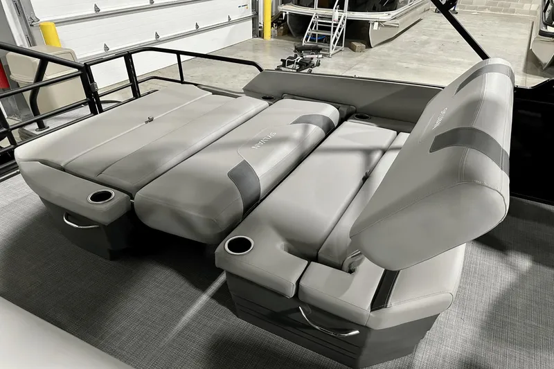 Slide: The Image of 2025 Sylvan L-5 boat interior with adjustable gray seating and cup holders. - 29
