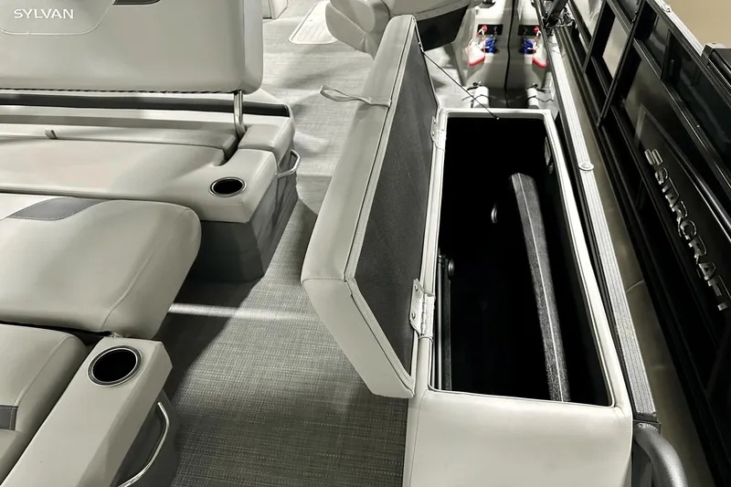 Slide: The Image of Interior of 2025 Sylvan L-5 boat with open storage compartment and cup holders. - 30
