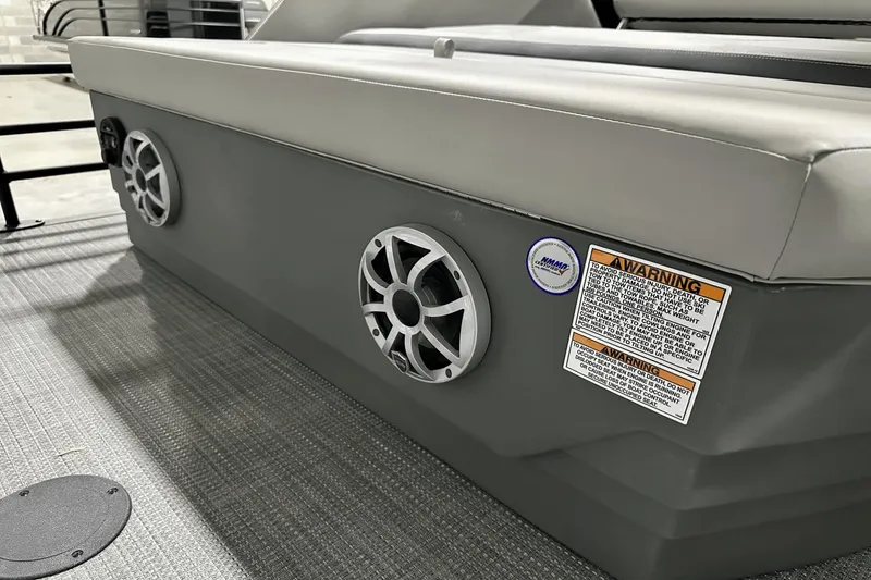 Slide: The Image of 2025 Sylvan L-5 boat interior with speakers and safety warning label. - 32