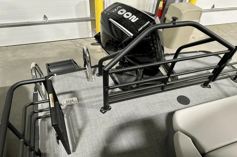 Slide: The Image of 2025 Sylvan L-5 boat with Mercury engine, featuring a spacious deck and safety railing. - 35