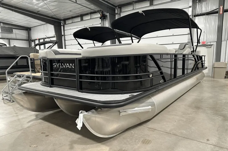 Slide: The Image of 2025 Sylvan L-5 pontoon boat in a showroom, featuring sleek design and modern amenities. - 4