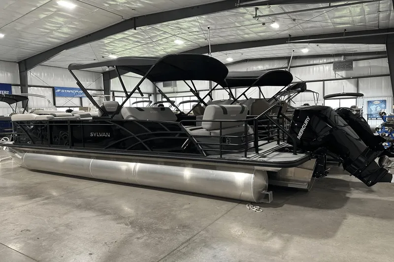Slide: The Image of 2025 Sylvan L-5 pontoon boat with Mercury engine in a showroom. - 6
