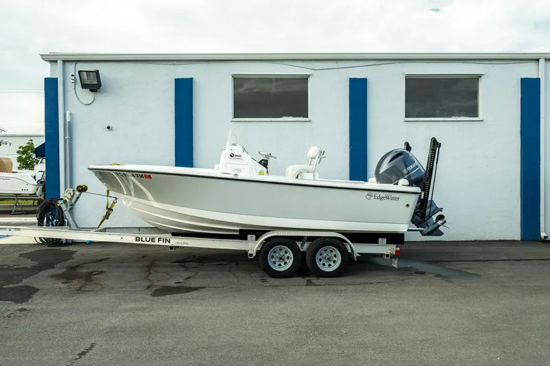 Slide: The Image of 2023 Edgewater 188CC boat on trailer, parked outside a building. - 0