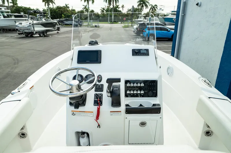Slide: The Image of 2023 Edgewater 188CC boat dashboard with steering wheel and controls. - 1