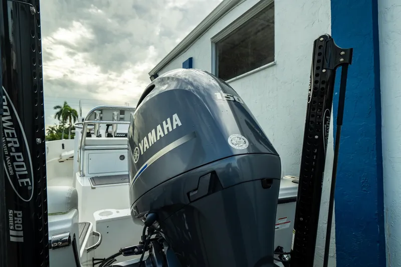 Slide: The Image of 2023 Edgewater 188CC boat with Yamaha outboard motor, docked near a building. - 13