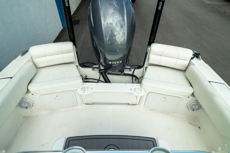 Slide: The Image of 2023 Edgewater 188CC boat interior with cushioned seating and outboard motor. - 15