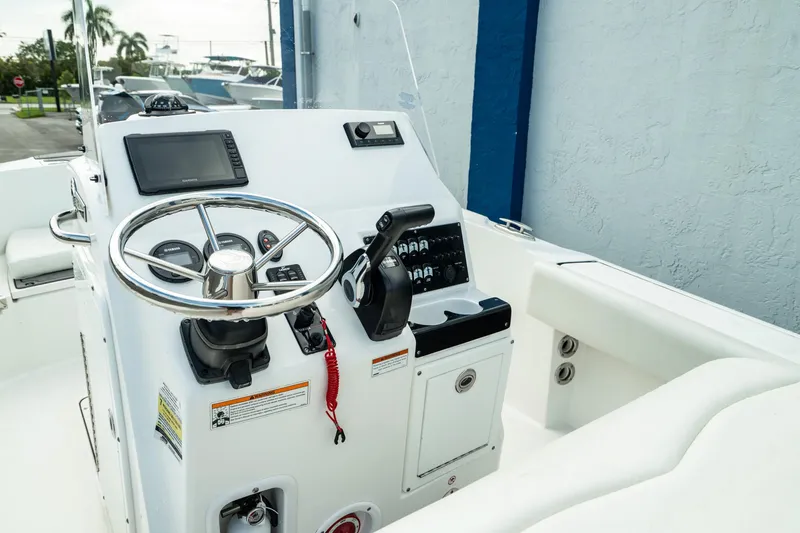 Slide: The Image of Edgewater 188CC 2023 boat console with steering wheel and controls. - 16
