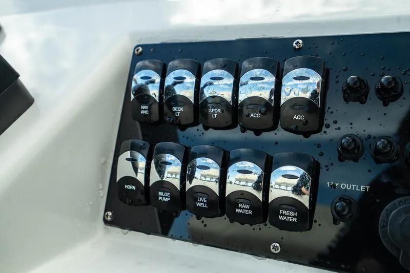 Slide: The Image of Control panel of 2023 Edgewater 188CC boat with labeled switches. - 18