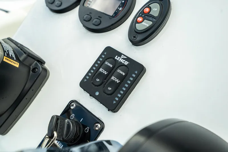 Slide: The Image of Close-up of 2023 Edgewater 188CC boat control panel with Lenco trim tab switches. - 20