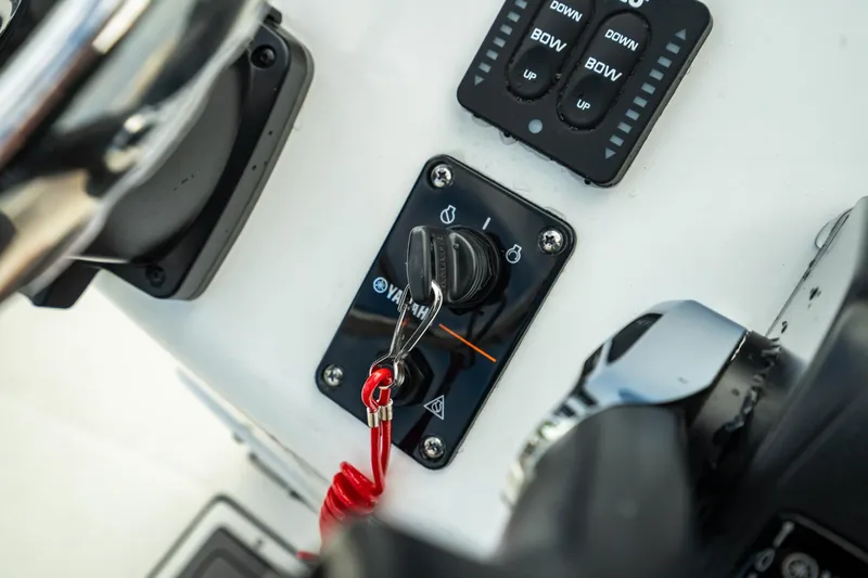 Slide: The Image of Close-up of 2023 Edgewater 188CC boat ignition switch and control panel. - 21