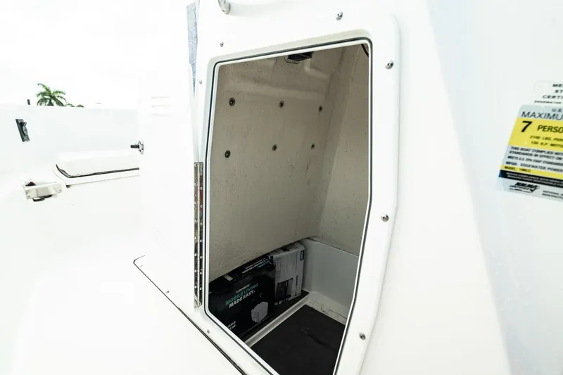 Slide: The Image of 2023 Edgewater 188CC boat storage compartment with safety label. - 25