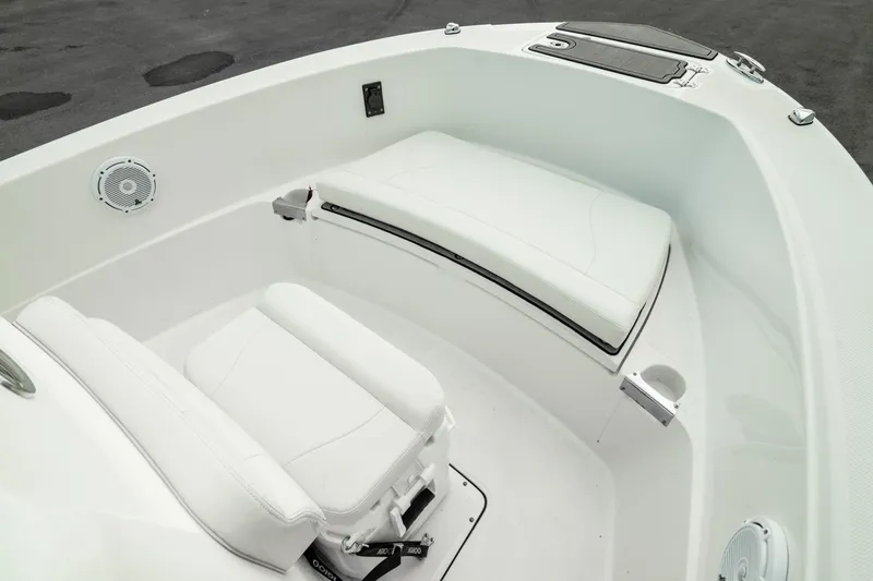 Slide: The Image of 2023 Edgewater 188CC boat interior with white seating and storage compartments. - 28