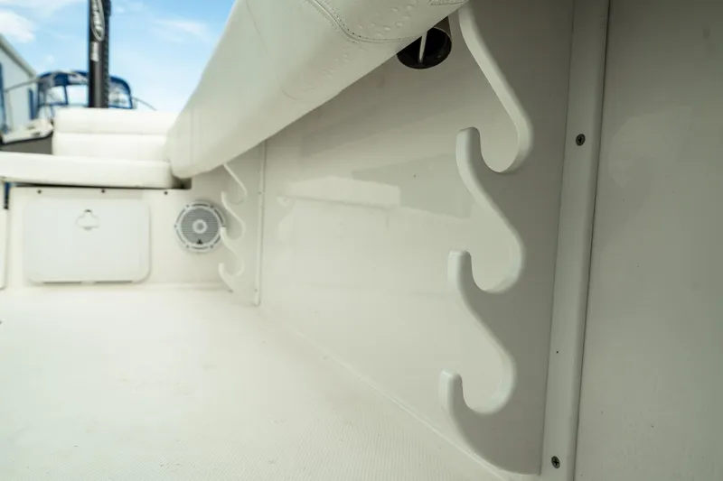 Slide: The Image of 2023 Edgewater 188CC boat interior with rod holders and speaker. - 35