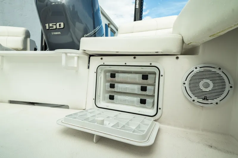 Slide: The Image of Edgewater 188CC 2023 boat storage compartment with Yamaha 150 engine in background. - 36