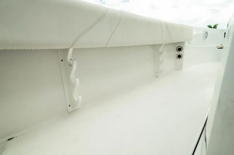 Slide: The Image of 2023 Edgewater 188CC boat interior with rod holders and white upholstery. - 39