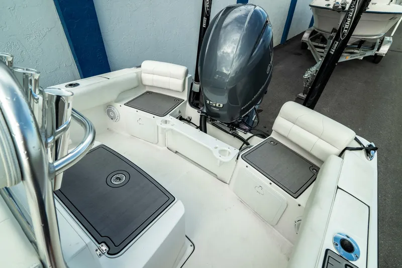 Slide: The Image of 2023 Edgewater 188CC boat interior with seating and outboard motor. - 7