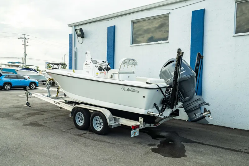 Slide: The Image of 2023 Edgewater 188CC boat on trailer, parked beside a building. - 9