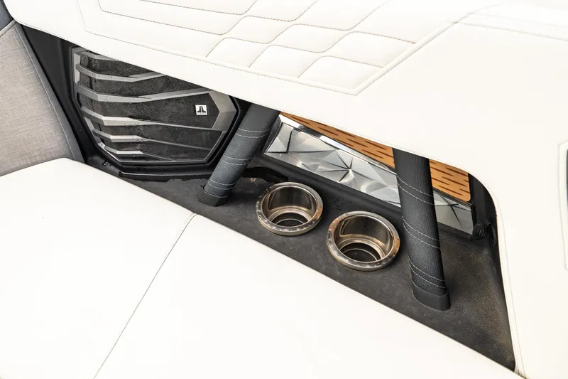 Slide: The Image of 2022 Nautique Super Air Nautique G23 interior with cup holders and speaker detail. - 10