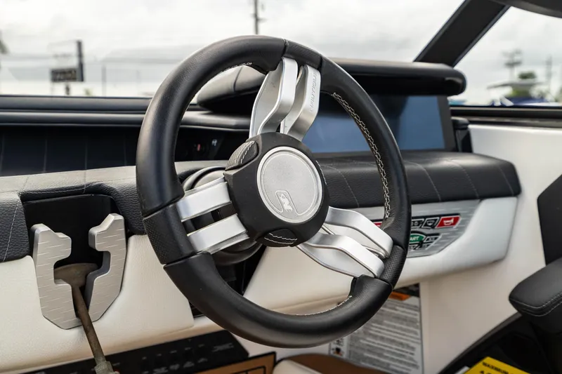 Slide: The Image of 2022 Nautique Super Air Nautique G23 steering wheel and dashboard interior. - 11
