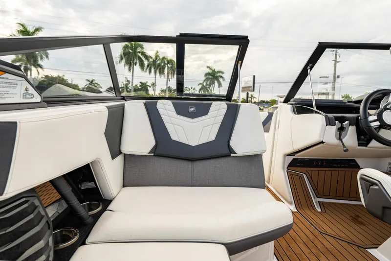 Slide: The Image of Interior of 2022 Nautique Super Air Nautique G23 boat with modern seating and dashboard. - 16
