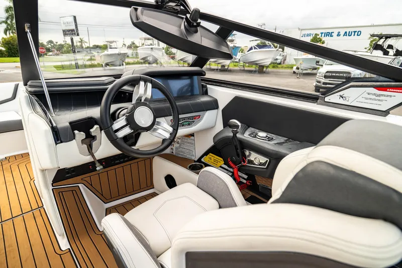 Slide: The Image of 2022 Nautique Super Air Nautique G23 interior with modern dashboard and steering wheel. - 2