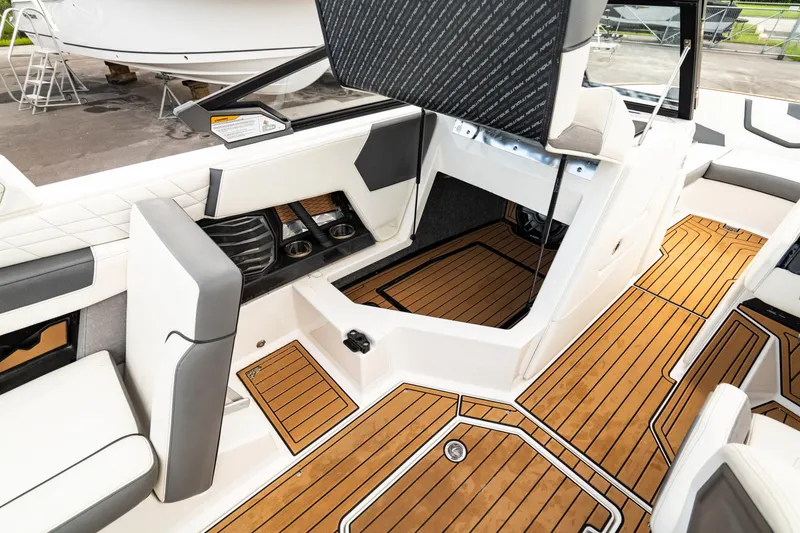 Slide: The Image of 2022 Nautique Super Air Nautique G23 interior with teak flooring and modern seating. - 21