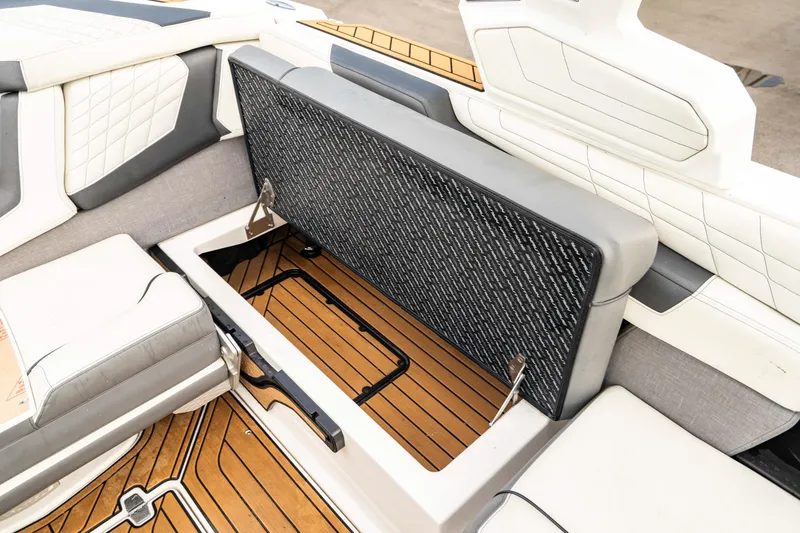 Slide: The Image of 2022 Nautique Super Air Nautique G23 interior storage compartment with cushioned seating. - 22