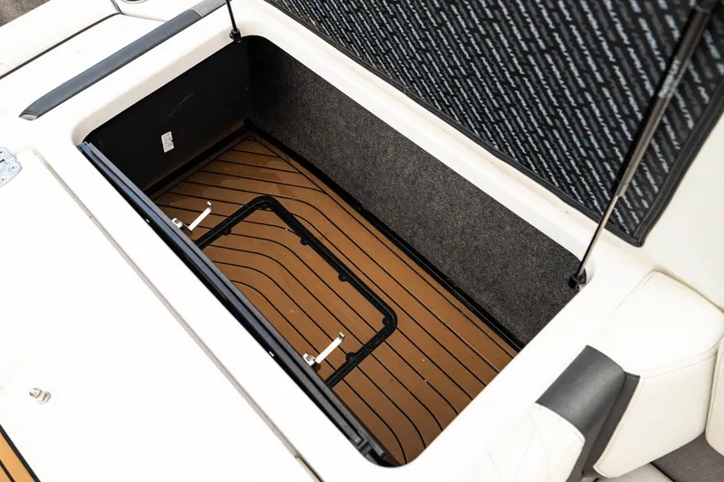 Slide: The Image of 2022 Nautique Super Air Nautique G23 storage compartment with teak flooring. - 25